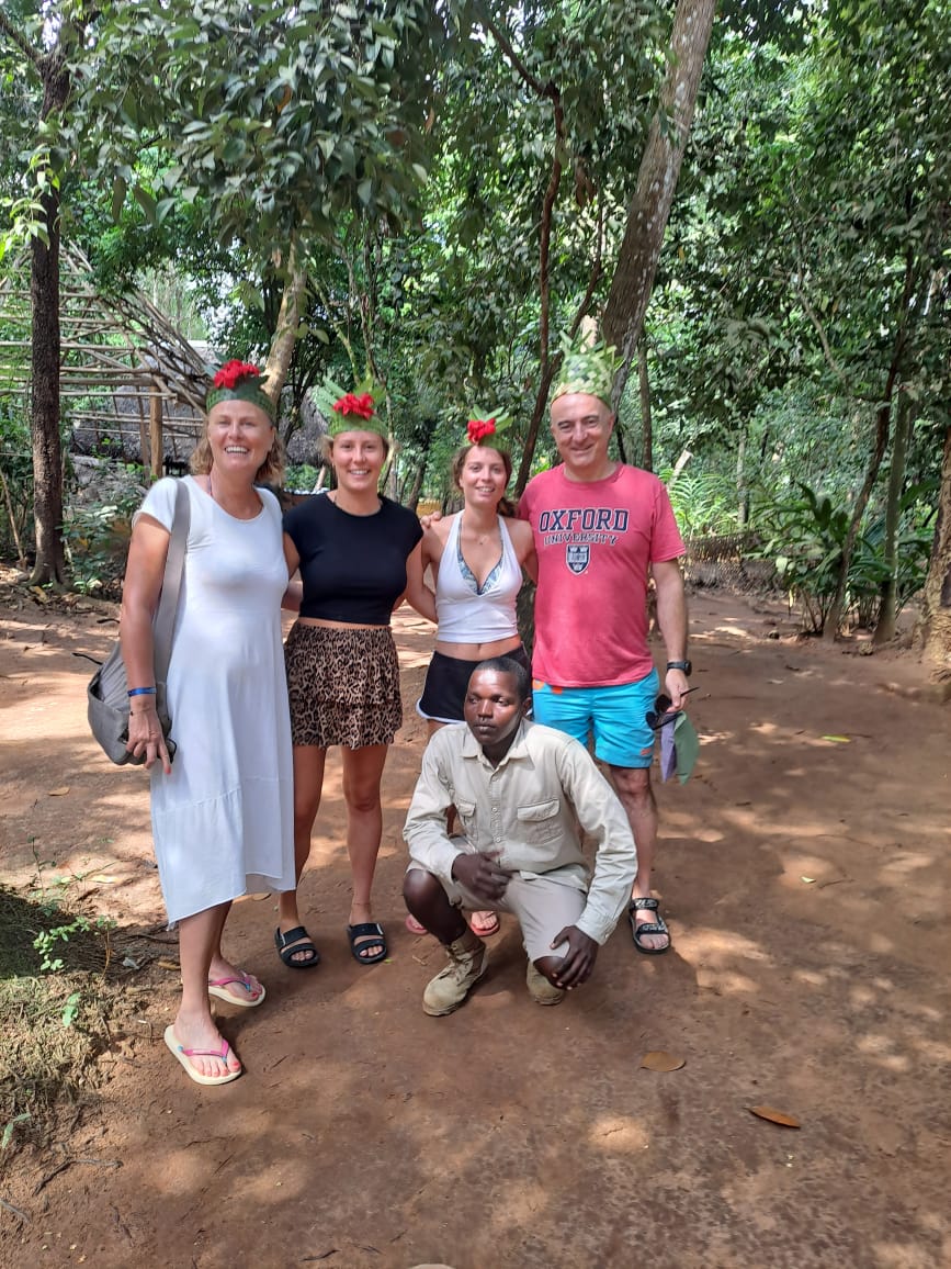 Mussa with a group of travelers in the forest
