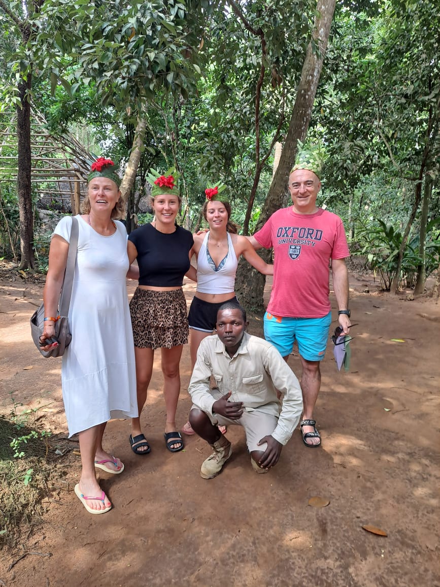 Mussa kneeling with a group of travelers